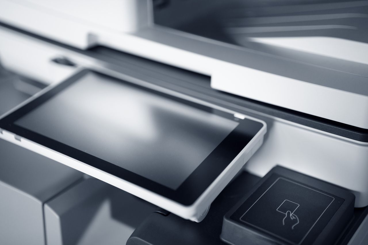 team-01 Close-up of a modern printer with a touchscreen interface in a professional office setting.
